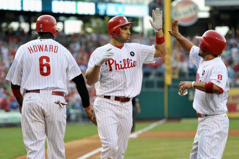 PHILADELPHIA, PA – JULY 26: Raul Ibanez #29 of the Philadelphia Phillies gets congratulated by teammates Ryan Howard #6 and Shane Victorino #8 after hitting a three-run home run during the game against the San Francisco Giants at Citizens Bank Park on July 26, 2011 in Philadelphia, Pennsylvania. (Photo by Drew Hallowell/Getty Images)