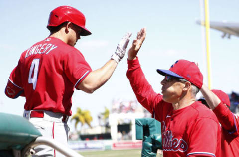 Scott Kingery #4 of the Philadelphia Phillies high fives manager Joe Girardi (Photo by Michael Reaves/Getty Images)