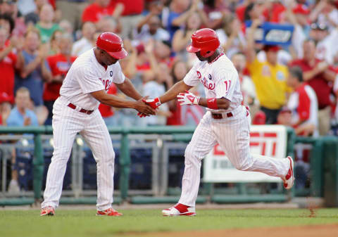 PHILADELPHIA , PA – AUGUST 17: Jimmy Rollins #11 of the Philadelphia Phillies shakes the hand of third base coach Juan Samuel #12 on his first inning homerun against the Arizona Diamondbacks at Citizens Bank Park on August 17, 2011 in Philadelphia, Pennsylvania. (Photo by Len Redkoles/Getty Images)