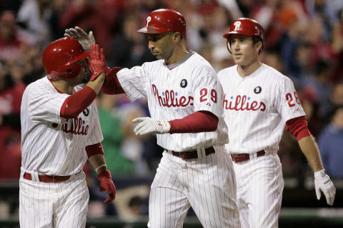 PHILADELPHIA, PA – SEPTEMBER 17: Raul Ibanez #29 of the Philadelphia Phillies is congratulated by Shane Victorino (L) as Chase Utley #26 follows after Ibanez hit a grand slam home run in the eighth inning as the Phillies defeated the St. Louis Cardinals 9-2 and clinched the National League East division championship on September 17, 2011 at Citizens Bank Park in Philadelphia, Pennsylvania. (Photo by Rich Schultz/Getty Images)