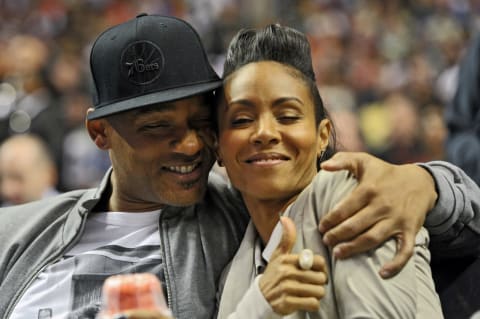 PHILADELPHIA, PA – MARCH 16: Entertainer Will Smith and his wife Jada Pinkett Smith share a moment on the sideline during the game between the Philadelphia 76ers and Miami Heat at the Wells Fargo Center on March 16, 2012 in Philadelphia, Pennsylvania. The Heat won 84-78. NOTE TO USER: User expressly acknowledges and agrees that, by downloading and or using this photograph, User is consenting to the terms and conditions of the Getty Images License Agreement. (Photo by Drew Hallowell/Getty Images)