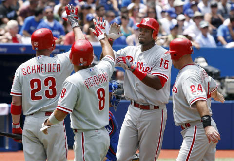 TORONTO, CANADA – JUNE 16: Brian Schneider #23, Shane Victorino #8, and Ty Wigginton #24 celebrates 3-run home run by John Mayberry Jr. #15 of the Philadelphia Phillies during MLB action at The Rogers Centre June 16, 2012 in Toronto, Ontario, Canada. (Photo by Abelimages/Getty Images)