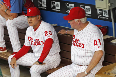 PHILADELPHIA – AUGUST 2: (L-R) Ryne Sandberg #23 and manager Charlie Manuel #41 of the Philadelphia Phillies sit in the dugout before a game against the Atlanta Braves at Citizens Bank Park on August 2, 2013 in Philadelphia, Pennsylvania. The Braves won 6-4. (Photo by Hunter Martin/Getty Images)