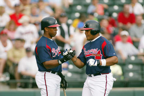 KISSIMMEE, FL- FEBRUARY 27: (L-R) Designated hitter Julio Franco #14 congratulates center fielder Andruw Jones #10 of the Atlanta Braves after Jones hit a home run against the Georgia Tech Yellow Jackets during their exhibition game at Cracker Jack Stadium at Disney’s Wide World of Sports Complex on February 27, 2003 in Kissimmee, Florida. The game was called in fourth inning due to the weather and ended in a 3-3 tie. (Photo by Rick Stewart/Getty Images)