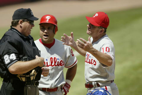 FLUSHING, NY – JULY 13: Placido Polanco #27 and Manager Larry Bowa of Philadelphia Phillies argue with home plate umpire Jerry layne after Layne threw Polanco out of the game during the National League game against the New York Mets at Shea Stadium on July 13, 2003 in Flushing, New York. The Mets won 4-3. (Photo by Ezra Shaw/Getty Images)