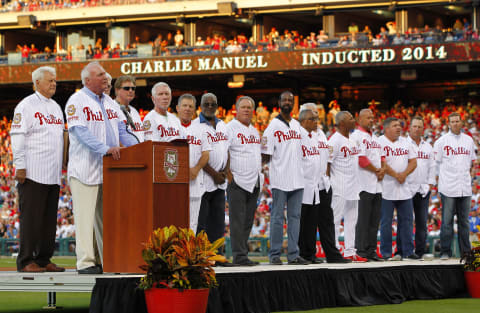 PHILADELPHIA, PA – AUGUST 09: Former manager Charlie Manuel of the Philadelphia Phillies talks about being inducted into the Phillies Wall of Fame as fellow members, Dallas Green, Jim Bunning, Steve Carlton, Mike Schmidt, Larry Bowa, Dick Allen, Greg Luzinski, Garry Maddox, Tony Taylor, Bob Boone, Juan Samuel, Darren Daulton, John Kruk, Mike Lieberthal and special guest Roy Halladay, listen in during a ceremony before the start of a game against the New York Mets at Citizens Bank Park on August 9, 2014 in Philadelphia, Pennsylvania. (Photo by Rich Schultz/Getty Images)