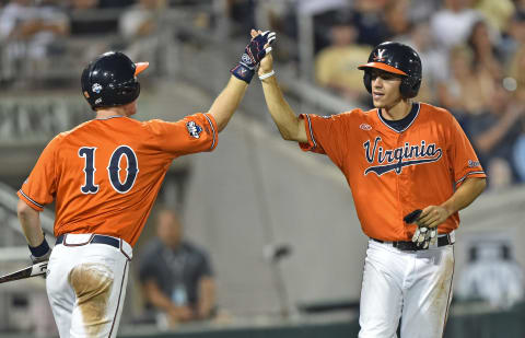 Omaha, NE – JUNE 24: Player Adam Haseley (R) of the Virginia Cavaliers celebrates after scoring with teammate Pavin Smith #10 against the Vanderbilt Commodores in the seventh inning during game three of the College World Series Championship Series on June 24, 2015 at TD Ameritrade Park in Omaha, Nebraska. (Photo by Peter Aiken/Getty Images)