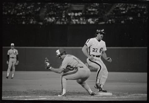 (Original Caption) Expos Pete Rose keeps Phillies’ Glenn Wilson close to first base on a pickoff attempt in the sixth inning, July 27th. Rose tied and broke Ty Cobb’s record for singles with two hits. The record is 3053 singles.