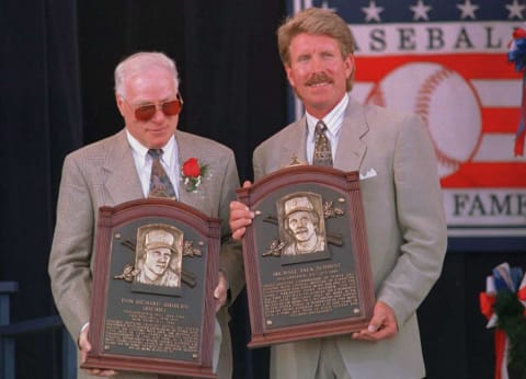 COOPERSTOWN, NY – JULY 30: Richie Ashburn (L) and Mike Schmidt (R) hold their plaques after their induction into the National Baseball Hall of Fame 30 July in Cooperstown, NY. The two former Philadelphia Phillies joined a total of five inductees in today’s ceremony. AFP PHOTO (Photo credit should read MARK D. PHILLIPS/AFP/Getty Images)