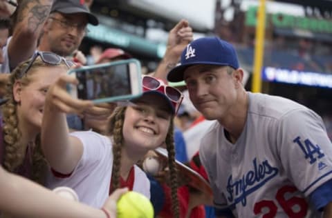 Chase Utley #26 of the Los Angeles Dodgers takes a selfie with a fan (Photo by Mitchell Leff/Getty Images)