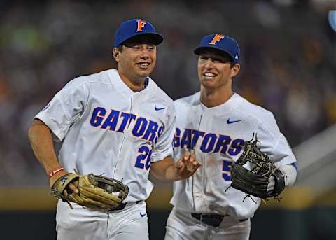 OMAHA, NE – JUNE 27: Players Nick Horvath #26 and Dalton Guthrie #5 of the Florida Gators celebrate after getting the final out against the LSU Tigers in the eighth inning during game two of the College World Series Championship Series on June 27, 2017 at TD Ameritrade Park in Omaha, Nebraska. (Photo by Peter Aiken/Getty Images)