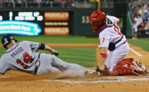 PHILADELPHIA – SEPTEMBER 24: Martin Prado #14 of the Atlanta Braves is tagged out at home plate by Chris Coste #27 of the Philadelphia Phillies on September 24, 2008 at Citizens Bank Park in Philadelphia, Pennsylvania. (Photo by Drew Hallowell/Getty Images)