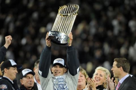 NEW YORK – NOVEMBER 04: Joe Girardi manager of the New York Yankees holds up the World Series trophy after their 7-3 win over the Philadelphia Phillies in Game Six of the 2009 MLB World Series at Yankee Stadium on November 4, 2009 in New York, New York. (Photo by Ron Vesely/MLB via Getty Images)