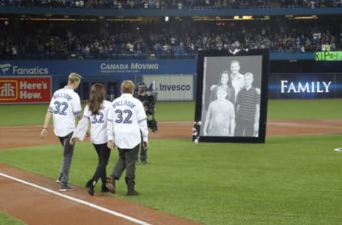 TORONTO, ON – MARCH 29: The family of the late Roy Halladay #32 of the Toronto Blue Jays during a pre-game ceremony honoring his memory as his widow Brandy Halladay and their two sons Braden and Ryan walk out onto the field on Opening Day during MLB game action against the New York Yankees at Rogers Centre on March 29, 2018 in Toronto, Canada. (Photo by Tom Szczerbowski/Getty Images) *** Local Caption *** Roy Halladay;Brandy Halladay;Braden Halladay;Ryan Halladay