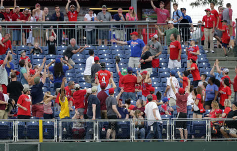 PHILADELPHIA, PA – MAY 26: A fan attempts to catch a home run ball off the bat of Nick Williams of the Philadelphia Phillies in the eighth inning during a game against the Toronto Blue Jays at Citizens Bank Park on May 26, 2018 in Philadelphia, Pennsylvania. The Phillies won 2-1. (Photo by Hunter Martin/Getty Images)