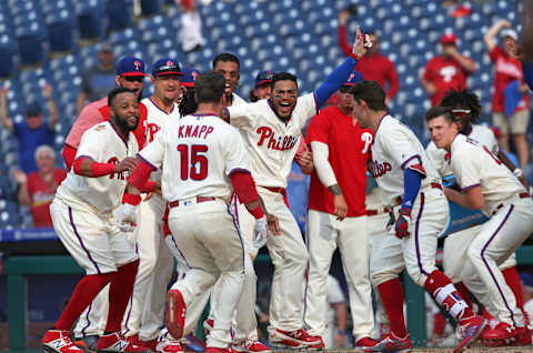 PHILADELPHIA, PA – JULY 1: The Philadelphia Phillies surround home plate to celebrate with Andrew Knapp #15 after he hit a game winning, walk off, solo home run in the 13th inning during a game against the Washington Nationals at Citizens Bank Park on July 1, 2018 in Philadelphia, Pennsylvania. The Phillies won 4-3 in 13 innings. (Photo by Hunter Martin/Getty Images)