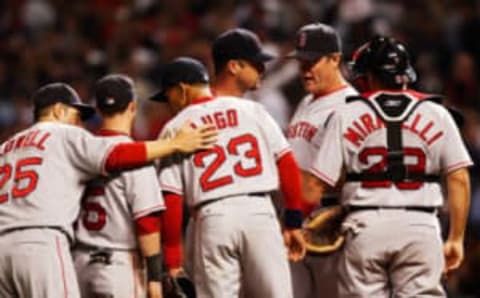 CLEVELAND – OCTOBER 16: Pitching coach John Farrell of the Boston Red Sox holds a meeting on the mound with Tim Wakefield