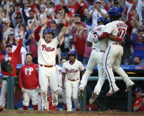 PHILADELPHIA, PA – OCTOBER 01: Nick Williams #5 of the Philadelphia Phillies jumps into the arms of Odubel Herrera #37 as he and Rhys Hoskins #17 score on Williams three-run inside the park home run against the New York Mets during the eighth inning of a game at Citizens Bank Park on October 1, 2017 in Philadelphia, Pennsylvania. (Photo by Rich Schultz/Getty Images)