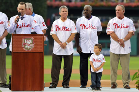 PHILADELPHIA, PA – AUGUST 10: Former Phillies catcher and Wall of Fame inductee, Mike Leiberthal addresses the crowd as he is watched by (L-R) Larry Bowa, Tony Taylor, his four year old son Merek and Greg Luzinski during ceremonies before the game against the St. Louis Cardinals at Citizens Bank Park on August 10, 2012 in Philadelphia, Pennsylvania. (Photo by Drew Hallowell/Getty Images)