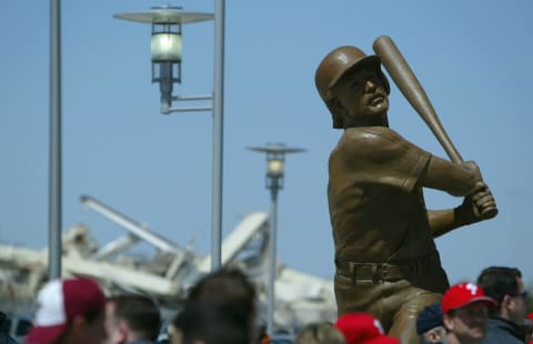 PHILADELPHIA – APRIL 15: A statue of Phillies great Mike Schmidt looms over the crowd, with the back drop of rubble from the remains of a demolished Veterans Stadium, as fans enter the park as the Philadelphia Phillies host the Cincinnati Reds for MLB action at Citizens Bank Park on April 15, 2004 in Philadelphia, Pennsylvania. (Photo by Doug Pensinger/Getty Images)