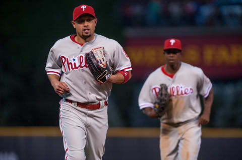 DENVER, CO – JULY 14: Shane Victorino #8 and Juan Pierre #10 of the Philadelphia Phillies run into the dugout from the outfield between half innings during a game against the Colorado Rockies at Coors Field on July 14, 2012 in Denver, Colorado. The Phillies defeated the Rockies 8-5. (Photo by Dustin Bradford/Getty Images)