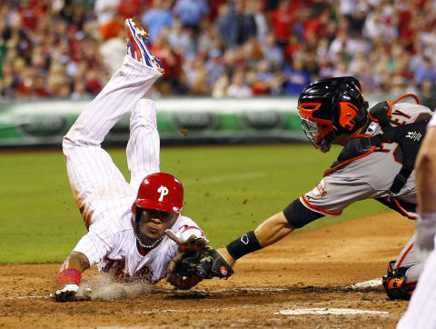 PHILADELPHIA, PA – AUGST 1: Michael Martinez #7 of the Philadelphia Phillies is tagged out at the plate by catcher Buster Posey #28 of the San Francisco Giants after attempting to score on a single hit by John Mayberry #15 in the seventh inning in a MLB baseball game on August 1, 2013 at Citizens Bank Park in Philadelphia, Pennsylvania. The Giants defeated the Phillies 2-1. (Photo by Rich Schultz/Getty Images)