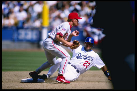 6 Apr 1997: Infielder Kevin Stocker (left) of the Philadelphia Phillies stands on second base as runner Eric Karros of the Los Angeles Dodgers slides in during the Dodgers 3-0 Opening Day loss at Dodger Stadium in Los Angeles, California. Mandatory Credit