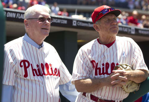 PHILADELPHIA, PA – JUNE 15: Hall of Fame pitcher Jim Bunning #14 and bench coach Larry Bowa #10 of the Philadelphia Phillies wait in the dugout prior to the game against the Chicago Cubs to throw out the ceremonial first pitch on June 15, 2014 at Citizens Bank Park in Philadelphia, Pennsylvania. (Photo by Mitchell Leff/Getty Images)