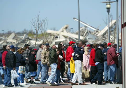 PHILADELPHIA – APRIL 15: Under the back drop of rubble from the remains of a demolished Veterans Stadium, fans line up to enter the park as the Philadelphia Phillies host the Cincinnati Reds for MLB action at the Citizens Bank Park on April 15, 2004 in Philadelphia, Pennsylvania. (Photo by Doug Pensinger/Getty Images)