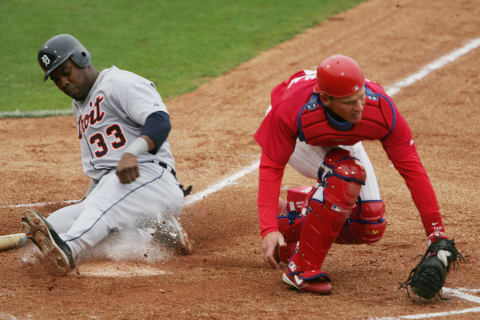 CLEARWATER, FL – MARCH 3: Outfielder Marcus Thames #33 of the Detroit Tigers slides through home plate against catcher Mike Lieberthal #24 of the Philadelphia Phillies during MLB Spring Training action at the Bright House Networks Field on March 3, 2005 in Clearwater, Florida. The Detroit Tigers defeated the Philadelphia Phillies 9-1. (Photo by Doug Pensinger/Getty Images)