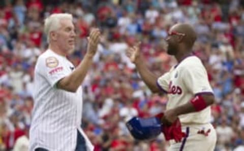 PHILADELPHIA, PA – JUNE 14: Shortstop Jimmy Rollins #11 of the Philadelphia Phillies hits a single in the bottom of the fifth inning against the Chicago Cubs and is congratulated by former Phillies third baseman Mike Schmidt #20 on June 14, 2014 at Citizens Bank Park in Philadelphia, Pennsylvania. This single makes Jimmy Rollins the all-time Phillies career hit leader with 2,235 hits. (Photo by Mitchell Leff/Getty Images)