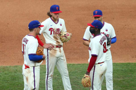 Infielders Rhys Hoskins #17, Alec Bohm #28, Neil Walker #12 and Didi Gregorius #18 of the Philadelphia Phillies (Photo by Rich Schultz/Getty Images)