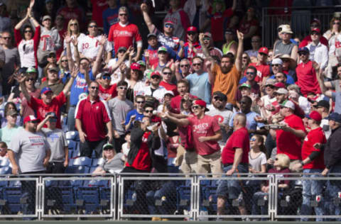 PHILADELPHIA, PA – APRIL 23: Fans try to catch the two run home run ball hit by Cesar Hernandez #16 of the Philadelphia Phillies (not pictured) in the bottom of the eighth inning against the Atlanta Braves at Citizens Bank Park on April 23, 2017 in Philadelphia, Pennsylvania. The Phillies defeated the Braves 5-2. (Photo by Mitchell Leff/Getty Images)