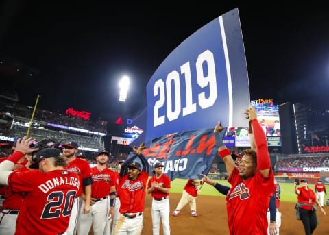 ATLANTA, GA – SEP 20: Ozzie Albies #1 of the Atlanta Braves and Ronald Acuna Jr. #13 hold up a 2019 banner at the conclusion of an MLB game against the San Francisco Giants in which they clinched the NL East at SunTrust Park on September 20, 2019 in Atlanta, Georgia. (Photo by Todd Kirkland/Getty Images)