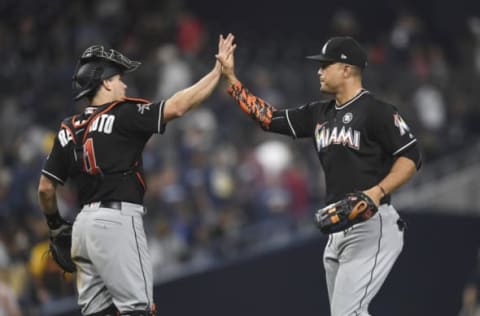 J.T. Realmuto #11 and Giancarlo Stanton #27 of the Miami Marlins (Photo by Andy Hayt/San Diego Padres/Getty Images)