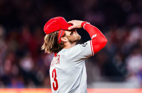 ATLANTA, GA - SEPTEMBER 29: Bryce Harper #3 of the Philadelphia Phillies puts on his hat to field after popping out to end the eighth inning of game 2 in a series between the Atlanta Braves and the Philadelphia Phillies at Truist Park on September 29, 2021 in Atlanta, Georgia. (Photo by Casey Sykes/Getty Images)