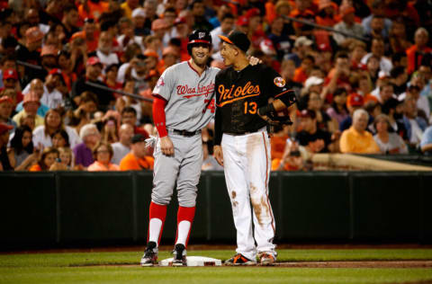 BALTIMORE, MD - JULY 10: Bryce Harper #34 of the Washington Nationals and Manny Machado #13 of the Baltimore Orioles talk during their game at Oriole Park at Camden Yards on July 10, 2015 in Baltimore, Maryland. (Photo by Rob Carr/Getty Images)