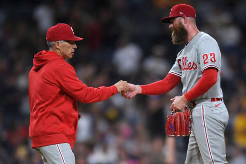 Aug 20, 2021; San Diego, California, USA; Philadelphia Phillies manager Joe Girardi (left) takes the ball from relief pitcher Archie Bradley (23) during a pitching change in the eighth inning against the San Diego Padres at Petco Park. Mandatory Credit: Orlando Ramirez-USA TODAY Sports