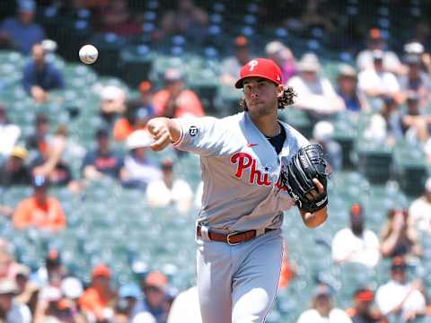 Jun 19, 2021; San Francisco, California, USA; Philadelphia Phillies starting pitcher Aaron Nola (27) throws the ball to first base to try and catch a San Francisco Giants runner talking a lead off during the first inning at Oracle Park. Mandatory Credit: Kelley L Cox-USA TODAY Sports