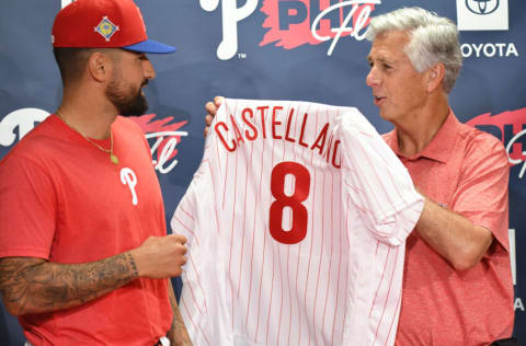 Mar 23, 2022; Clearwater, Florida, USA; Philadelphia Phillies president of baseball operations Dave Dombrowski gives outfielder Nick Castellanos (8) his new jersey before the start of the game against the Toronto Blue Jays during spring training at BayCare Ballpark. Mandatory Credit: Jonathan Dyer-USA TODAY Sports