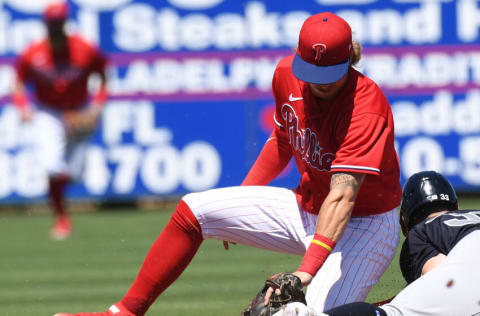 Mar 25, 2022; Clearwater, Florida, USA; Philadelphia Phillies shortstop Bryson Stott (73) attempts to tag out New York Yankees right fielder Tim Locastro (33) in the second inning during spring training at BayCare Ballpark. Mandatory Credit: Jonathan Dyer-USA TODAY Sports