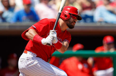 Mar 30, 2022; Clearwater, Florida, USA; Philadelphia Phillies left fielder Kyle Schwarber (12) hits a base hit against the Detroit Tigers in the third inning during spring training at BayCare Ballpark. Mandatory Credit: Nathan Ray Seebeck-USA TODAY Sports