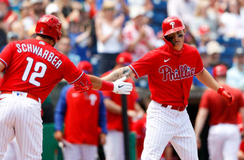 Apr 3, 2022; Clearwater, Florida, USA; Philadelphia Phillies designated hitter Kyle Schwarber (12) congratulates center fielder Mickey Moniak (16) after hitting a home run against the Detroit Tigers in the fourth inning during spring training at BayCare Ballpark. Mandatory Credit: Nathan Ray Seebeck-USA TODAY Sports