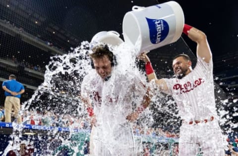 Jun 13, 2022; Philadelphia, Pennsylvania, USA; Philadelphia Phillies first baseman Rhys Hoskins (17) is doused with water by left fielder Kyle Schwarber (12) after hitting a game winning walk off double during the ninth inning against the Miami Marlins at Citizens Bank Park. Mandatory Credit: Bill Streicher-USA TODAY Sports