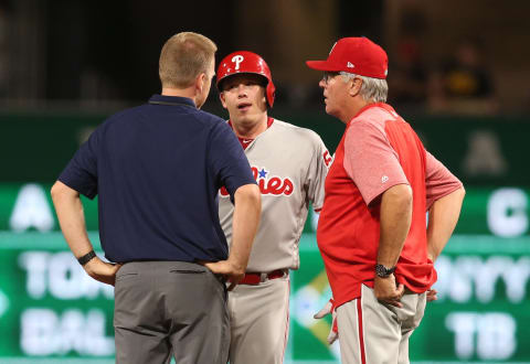 May 19, 2017; Pittsburgh, PA, USA; Philadelphia Phillies starting pitcher Jeremy Hellickson (middle) is attended to by a team trainer and manager Pete Mackanin (45) after suffering an apparent injury on a double against the Pittsburgh Pirates during the seventh inning at PNC Park. Hellickson would leave the game. Mandatory Credit: Charles LeClaire-USA TODAY Sports