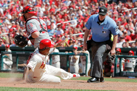 Jun 10, 2017; St. Louis, MO, USA; St. Louis Cardinals starting pitcher Carlos Martinez (18) scores a run in front of Philadelphia Phillies catcher Cameron Rupp (29) during the seventh inning at Busch Stadium. Mandatory Credit: Scott Kane-USA TODAY Sports