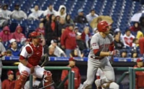 Jun 2, 2015; Philadelphia, PA, USA; Cincinnati Reds first baseman Joey Votto (19) hits an hits an RBI single during the third inning against the Philadelphia Phillies at Citizens Bank Park. Mandatory Credit: Eric Hartline-USA TODAY Sports