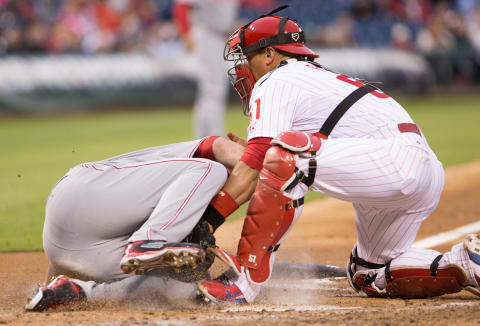 Jun 4, 2015; Philadelphia, PA, USA; Cincinnati Reds starting pitcher Anthony DeSclafani (28) scores at home on an obstruction error by Philadelphia Phillies catcher Carlos Ruiz (51) during the fifth inning at Citizens Bank Park. Mandatory Credit: Bill Streicher-USA TODAY Sports