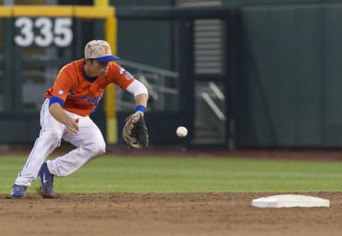 Jun 17, 2015; Omaha, NE, USA; Florida Gators second baseman Dalton Guthrie (5) fields a ground ball against the Miami Hurricanes in the fifth inning in the 2015 College World Series at TD Ameritrade Park. The Gators won 10-2. Mandatory Credit: Bruce Thorson-USA TODAY Sports