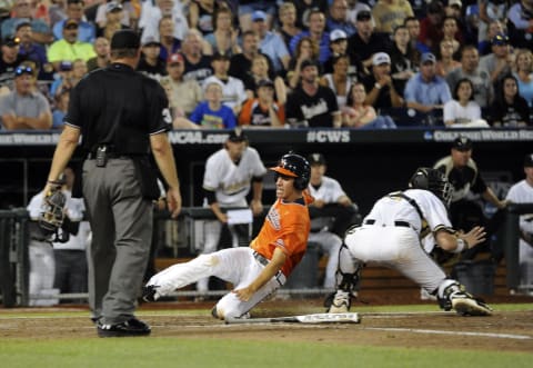 Jun 24, 2015; Omaha, NE, USA; Virginia Cavaliers center fielder Adam Haseley (7) scores during the fifth inning against the Vanderbilt Commodores in game three of the College World Series Finals at TD Ameritrade Park. Mandatory Credit: Steven Branscombe-USA TODAY Sports